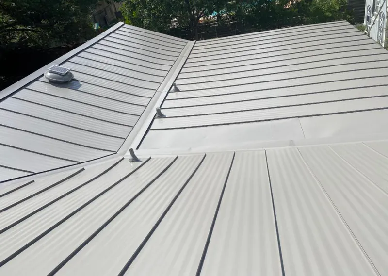 Solar attic fan installed on a metal roof for Roof Ventilation in Grosse Pointe Farms